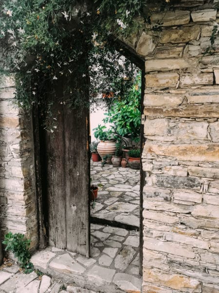 Open Door In Rock Wall Revealing Courtyard